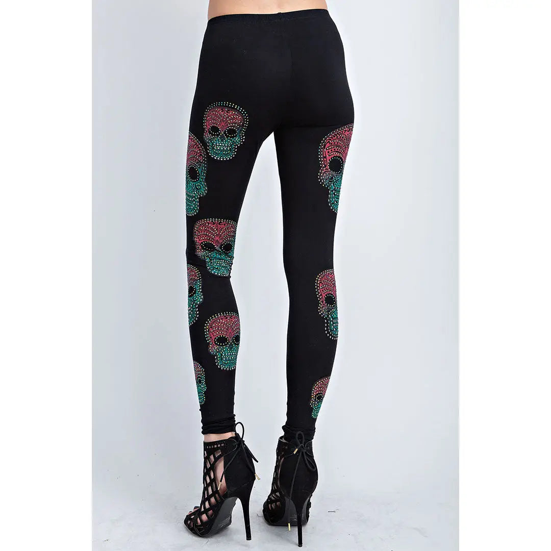 Black full-length leggings with scattered sugar skull prints in teal and pink