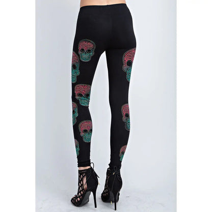 Black full-length leggings with scattered sugar skull prints in teal and pink