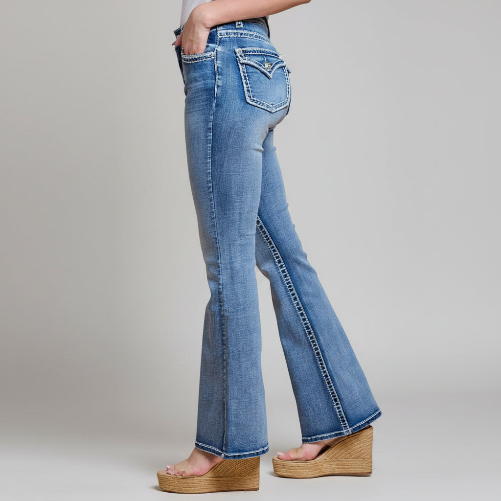 Women’s blue denim bootcut jeans with high waist, stitched pockets, and curved seams