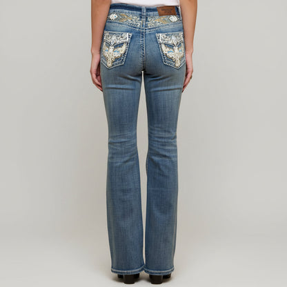 Blue denim bootcut jeans with jeweled eagle embroidery on front pockets