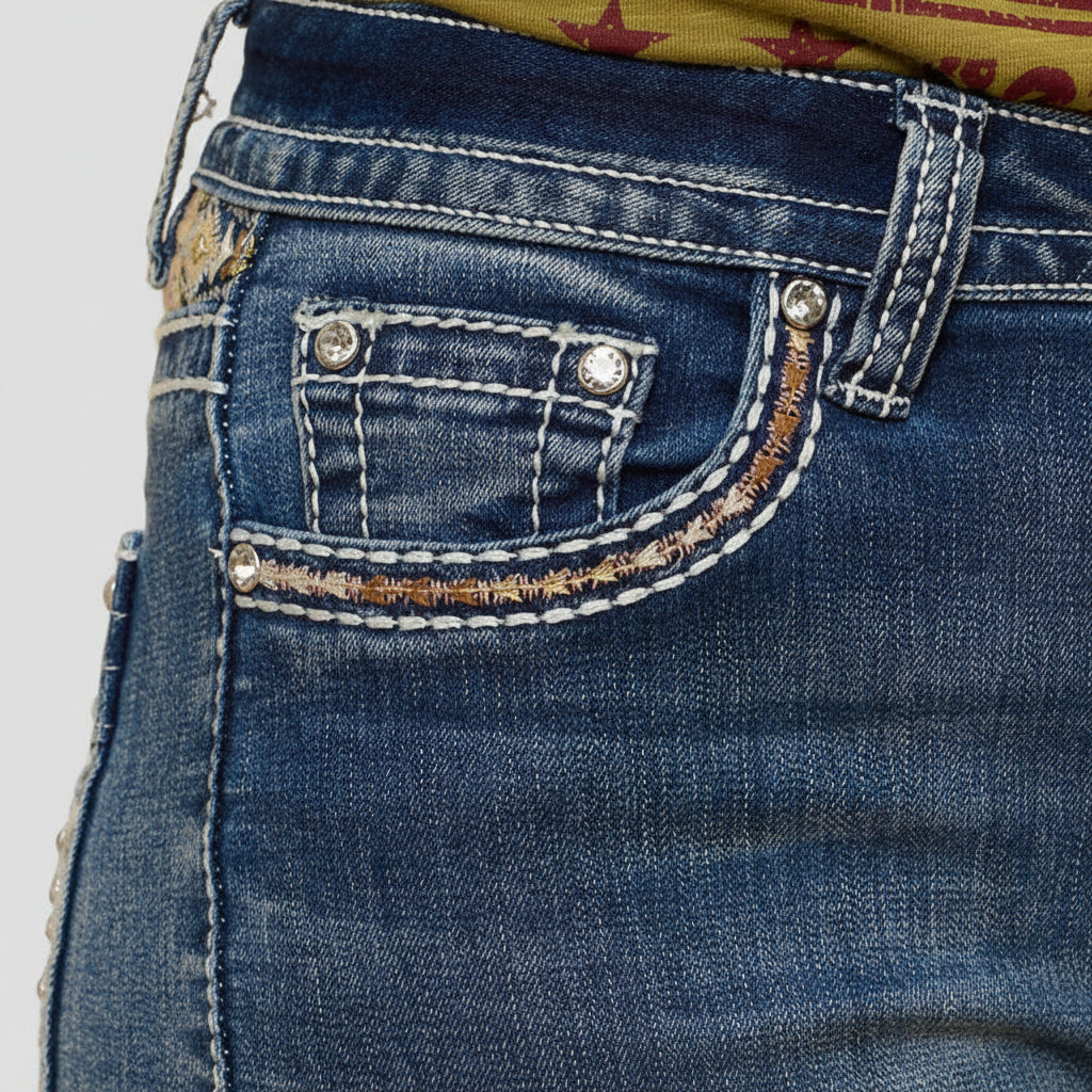 Blue front pocket with decorative embroidery trim and silver snap hardware.