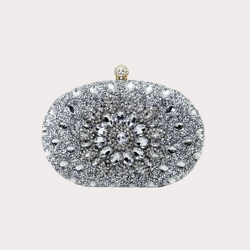 Silver rhinestone oval evening clutch with ornate flower clasp