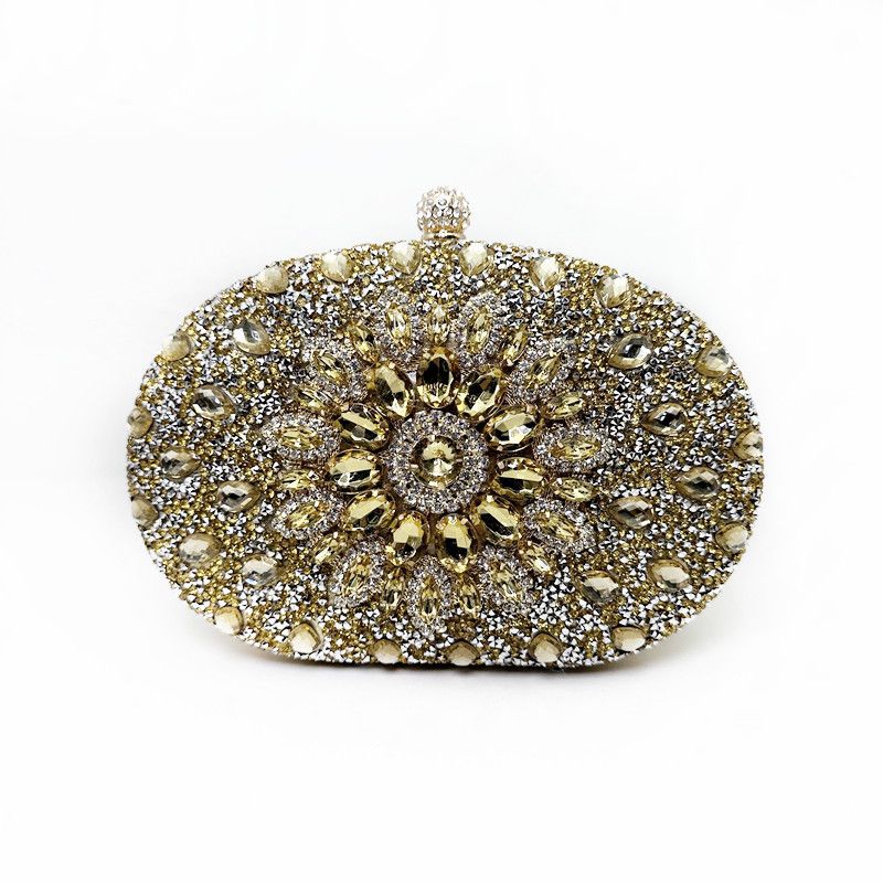 Gold rhinestone oval evening clutch with central sunburst flower clasp