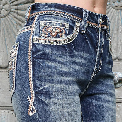 Jeans back-pocket detail, blue denim with ornate embroidery and decorative stitched panels