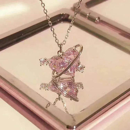 Pink gemstone heart pendant necklace on silver chain, floral star accents