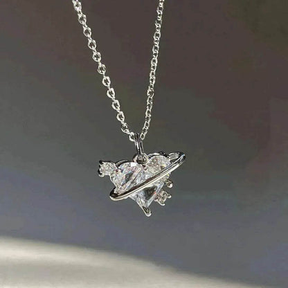 Silver-tone necklace with clear heart gemstone pendant and starburst details