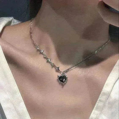Silver-tone necklace with dark heart pendant and star-like pave accents