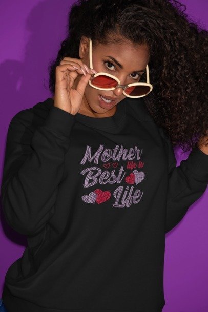 Black long-sleeve rhinestone shirt with “Mother Best Life” script and heart detail