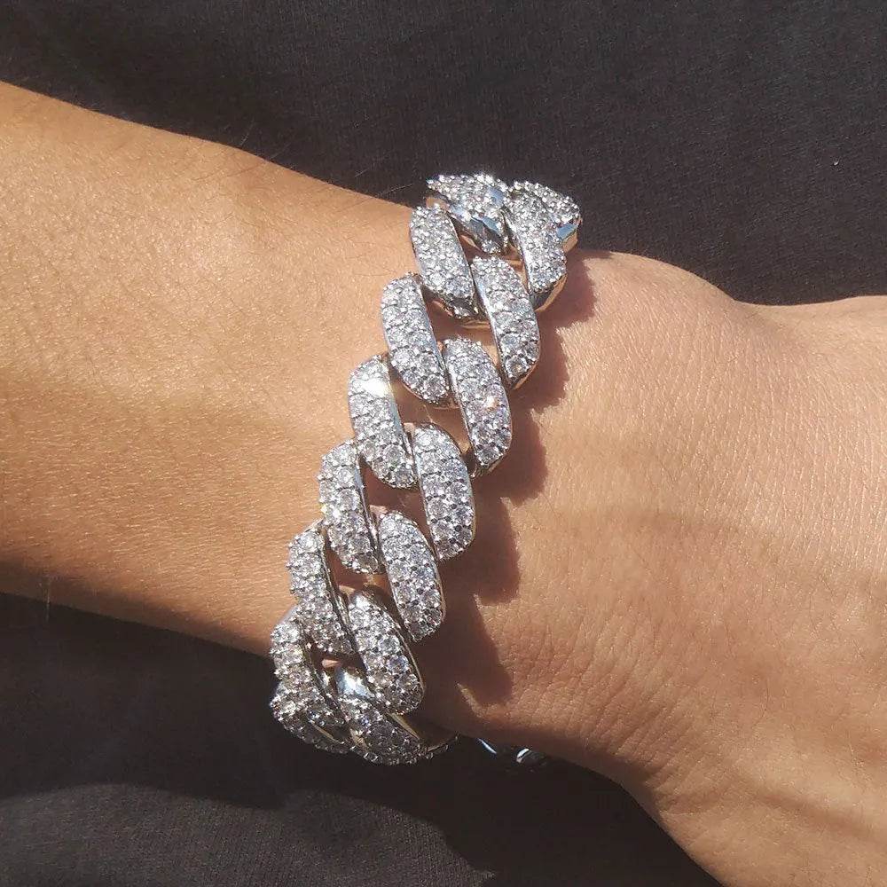 Silver diamond Cuban link bracelet on wrist, stacked oval links