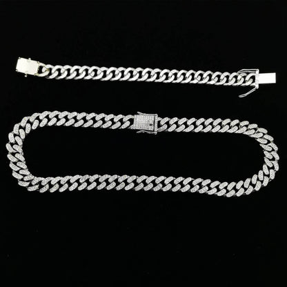 Silver diamond Cuban link bracelet with rectangular clasp on dark background.