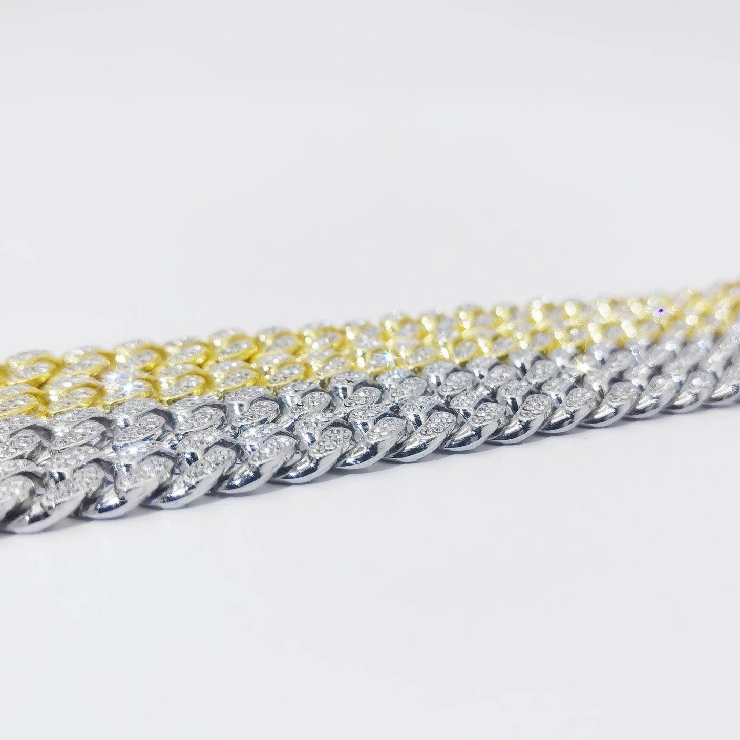 Diamond Cuban link bracelet close-up, gold and silver chain sections.
