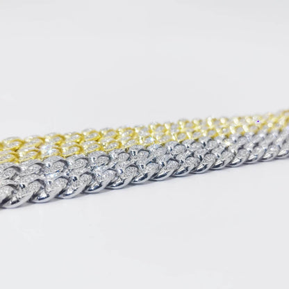 Diamond Cuban link bracelet close-up, gold and silver chain sections.