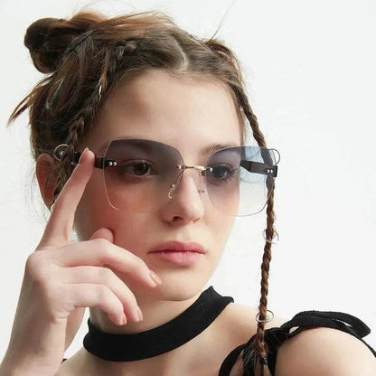 Women's sunglasses on model, with pink-tinted gradient lenses and thin metal frame