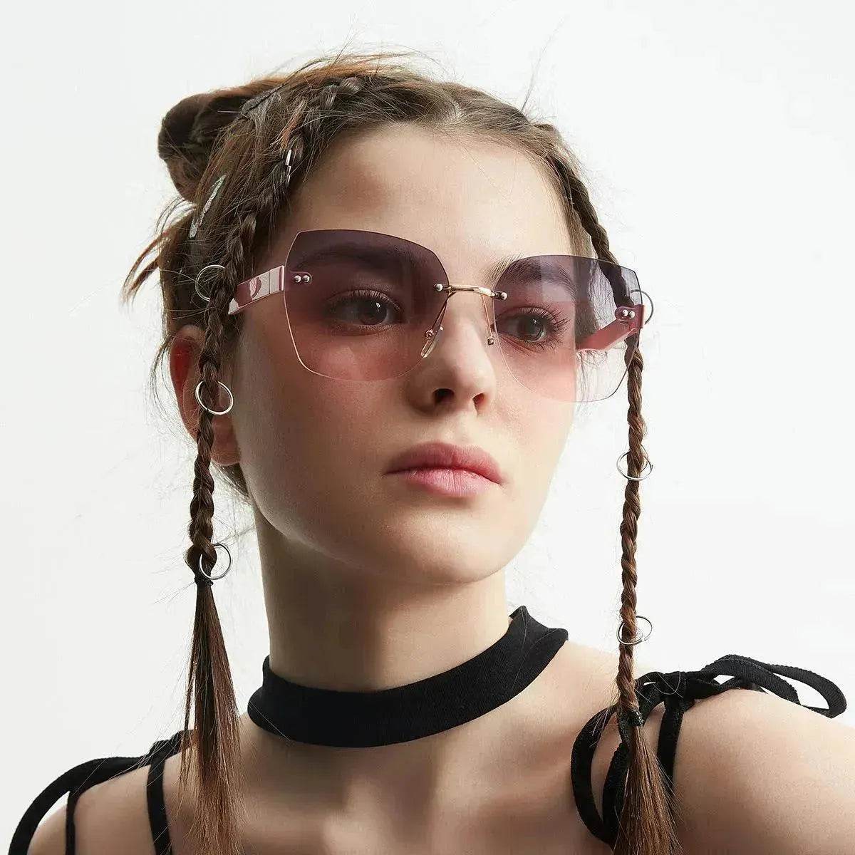 Women's sunglasses on model with rose-tinted lenses and gold metal frame