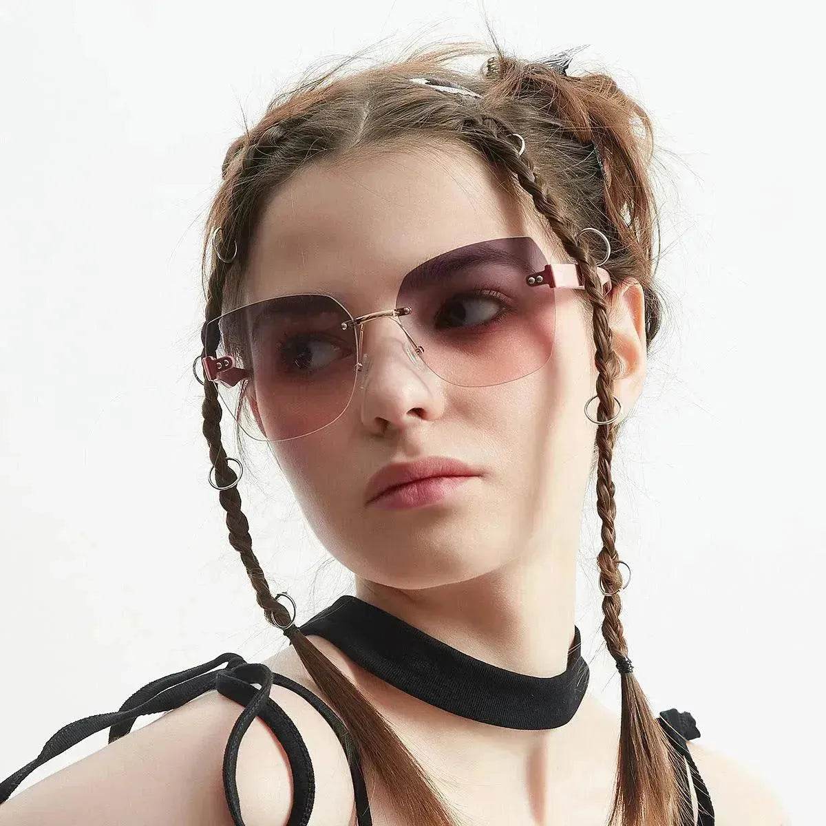 Women's sunglasses on model with dark brown lenses and thin metal frame