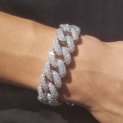 Silver diamond Cuban link bracelet on wrist, close-up of oval links