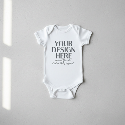 White short-sleeve baby onesie with 'YOUR DESIGN HERE' front print