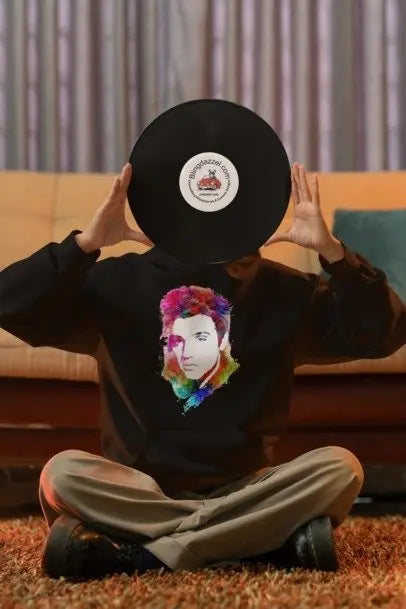 Black long-sleeve graphic shirt with circular logo patch and portrait print on back